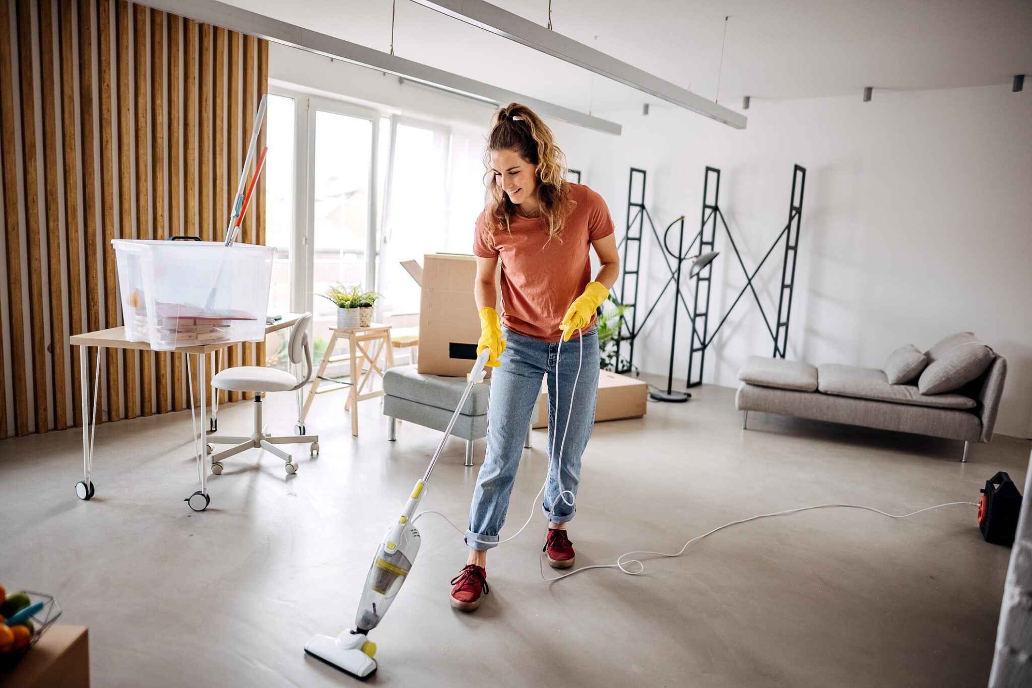 Person tidying up bright, minimalist home