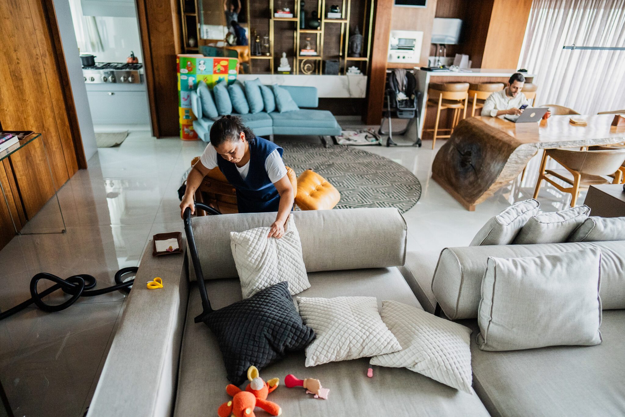 Woman vacuuming a modern living room