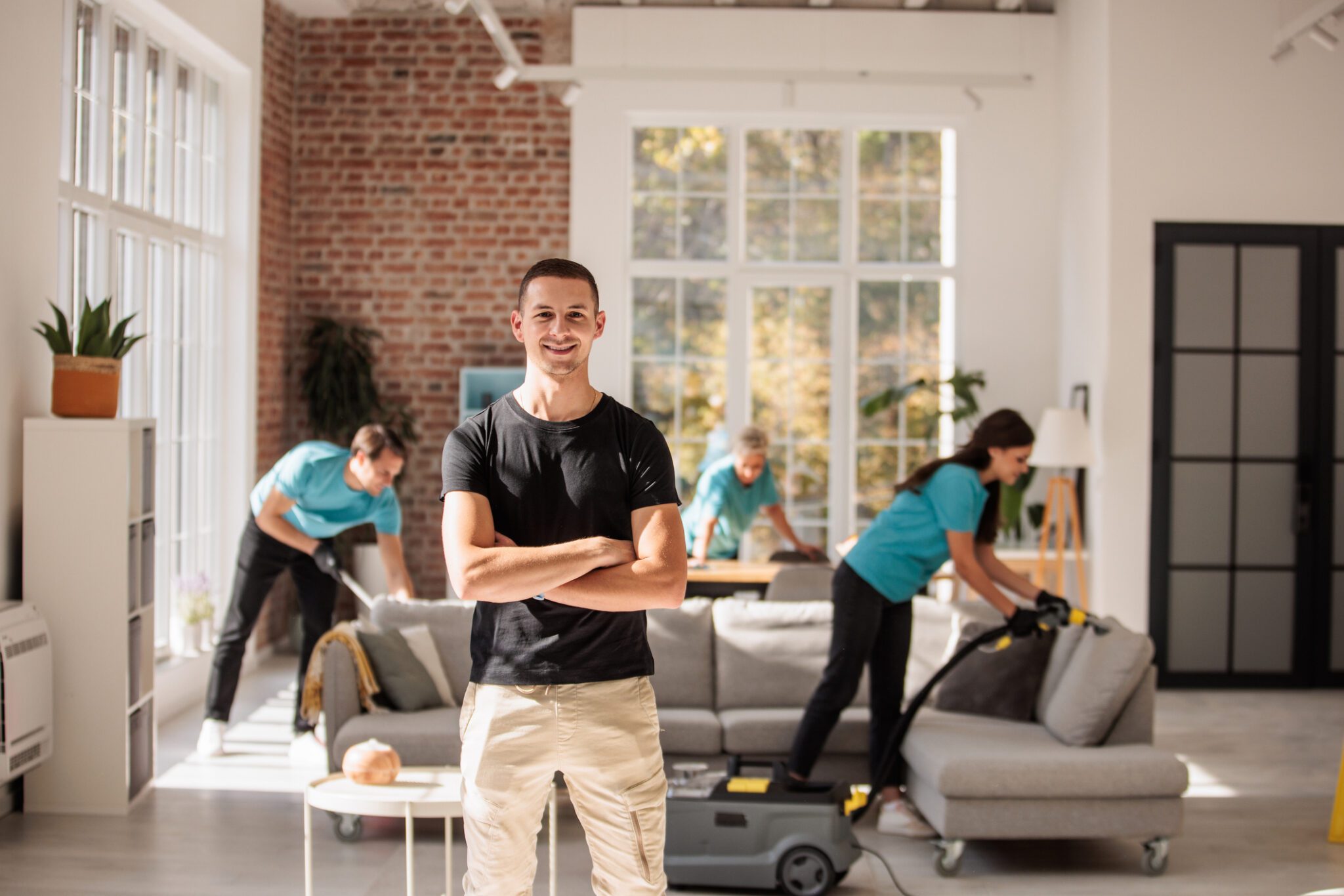 Cleaning team working in bright apartment